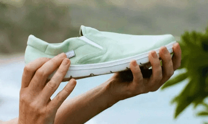 A video of a person holding a Lems minimalist barefoot slip on shoe and scrunching it into a ball, to demonstrate the shoe flexibility.