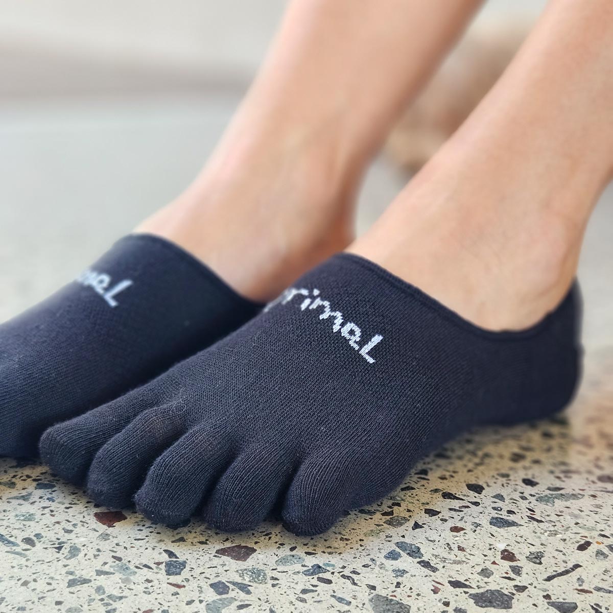 Close up of a pair Black Bprimal Everyday Five-Toe Socks - Hidden worn indoors