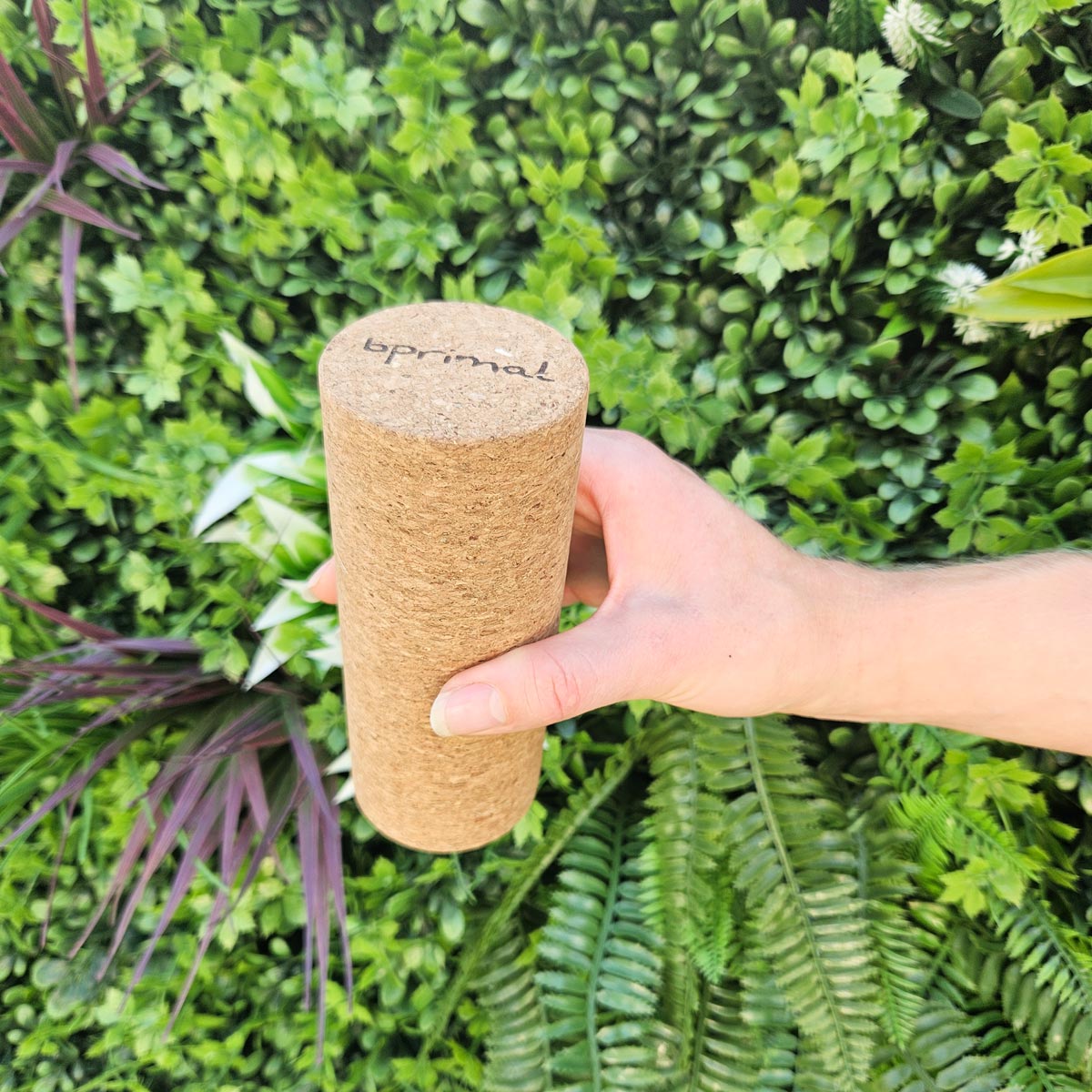 Person holding Bprimal cork roller with &