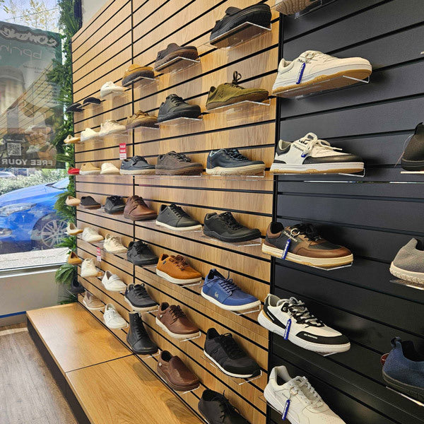Bprimal Northcote Store interior shoe display wall with various barefoot shoes on the shelves.