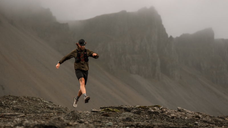 Altra Lone Peak 9+ mens basalt trail running shoes worn on rugged mountain terrain with zero drop design and wide toe box