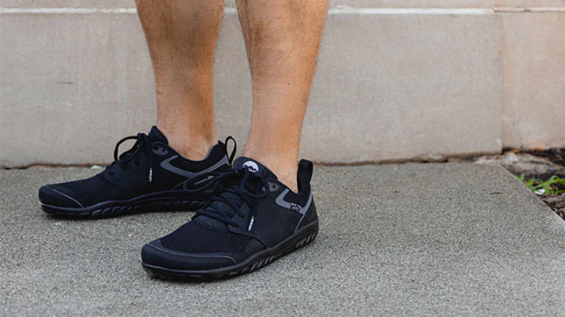 Lems - Primal Zen barefoot shoes with a wide toe box worn outdoors on a concrete footpath, supporting natural foot movement and everyday comfort.