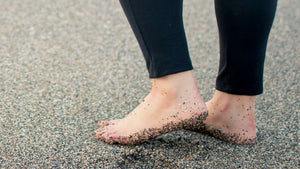 Strong Barefoot feet walking on the sand
