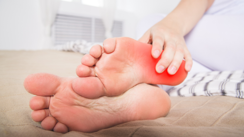 person holding foot with highlighted heel pain area, showing pain on heel while walking and plantar fascia discomfort