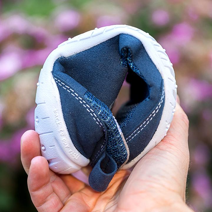 Flexible navy barefoot shoe scrunched into a ball